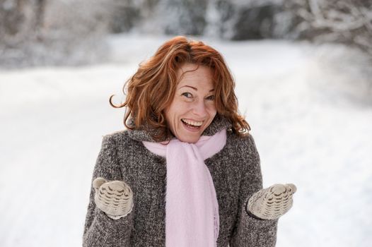 Portrait of happy red-haired woman in winters day.