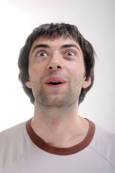 Surprised young man on white background