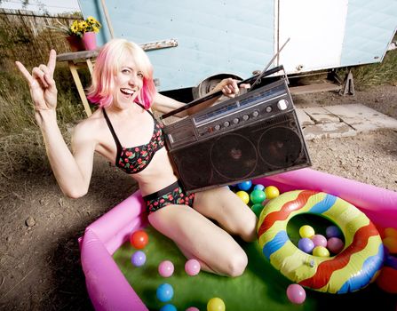 Woman with a boom box in an inflatable play pool