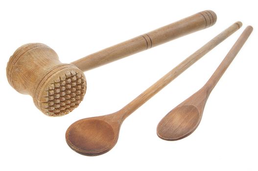 Mallet and two wooden spoons on white