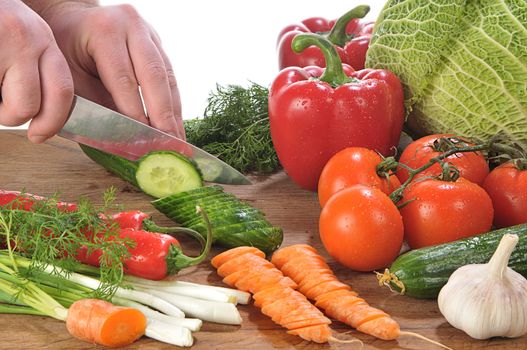 close-up shot of someone cutting up colorful different vegetables