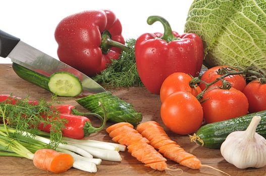 close-up shot of someone cutting up colorful different vegetables