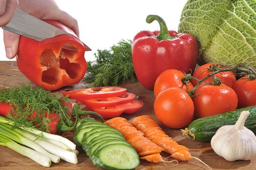 close-up shot of someone cutting up colorful different vegetables