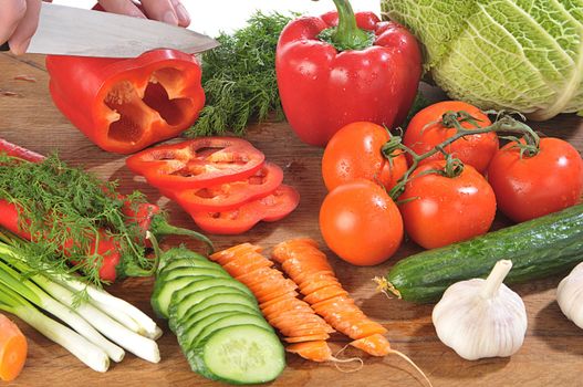 close-up shot of someone cutting up colorful different vegetables