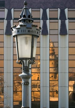 Old street lamp reflected in the background surface.