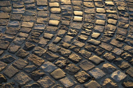 Cobblestone road the setting sun.