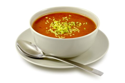 Delicious, creamy tomato soup in ceramic bowl on white