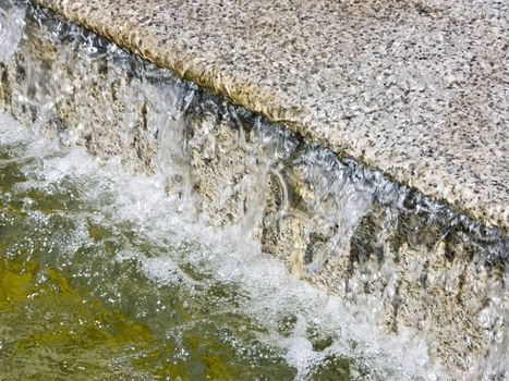 The image of a cascade fountain - steps on which runs water.