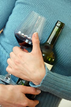 wine glass and bottle in woman's hug