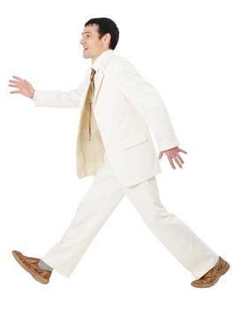 Happy businessman in a white suit somewhere in a hurry