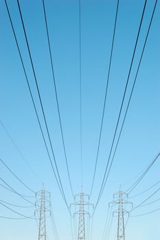 Three power masts with power lines stretching from them
