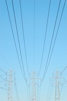 Three power masts with power lines stretching from them
