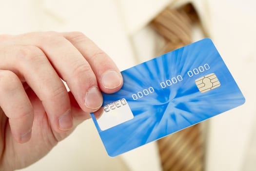 Businessman shows a blue plastic credit card