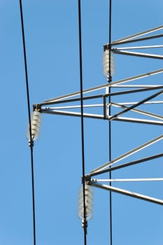 Power mast fixtures seen from below, with three parallel power lines.
