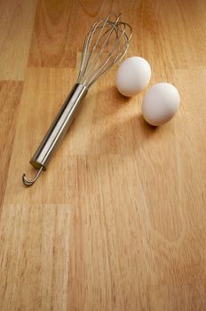 Mixer and Eggs on a wooden background.