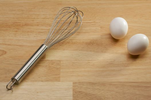 Mixer and Eggs on a wooden background.