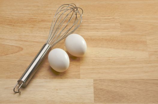 Mixer and Eggs on a wooden background.