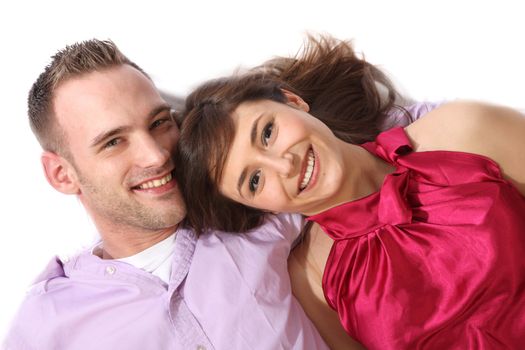 Young, happy couple lying on the floor and laughs