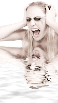 Studio portrait of a young blond woman in despair