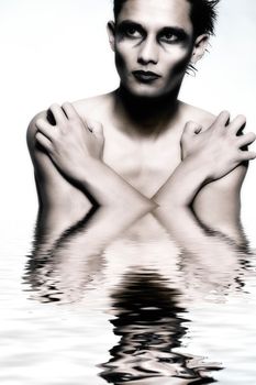 Studio portrait of mixed race young man looking protective