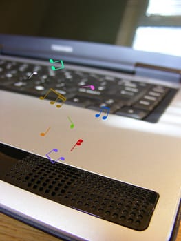 Close-up photo of a computer with illustrated musical notes coming from the speaker