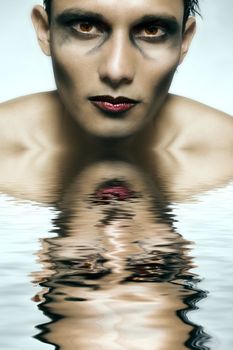 Studio portrait of mixed race young man with extreme make-up