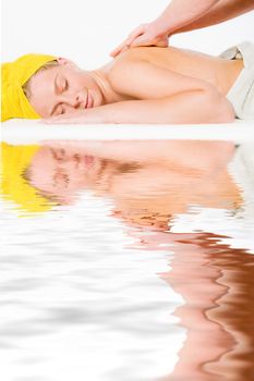 Studio portrait of a spa girl getting a shoulder massage