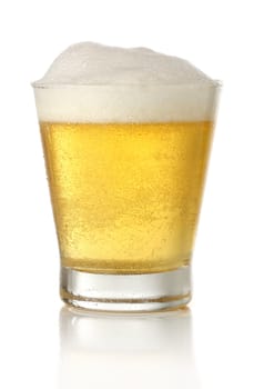 Glass of cold and fresh golden beer, over white background