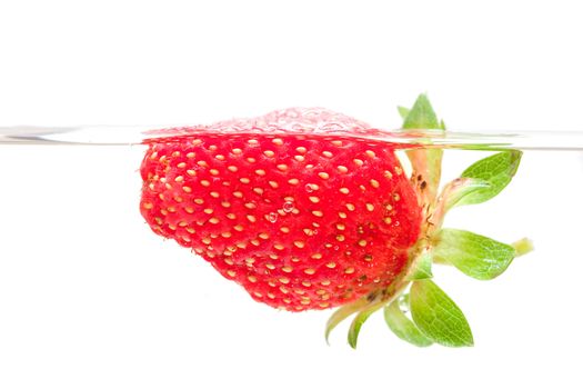 close-up strawberry swim in water, isolated over white background