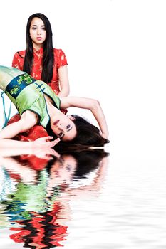 Studio portrait of two beautiful mixed race vietnamese sisters