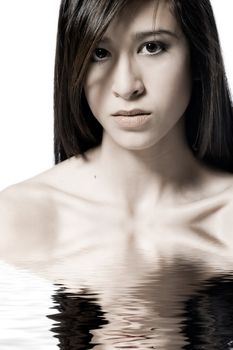 Studio portrait of a beautiful mixed race, vietnamese girl with an angry look