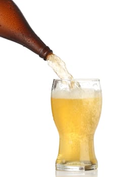 Pouring cold beer into glass isolated on white