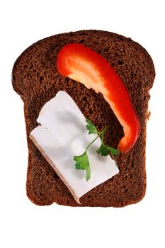 Piece of black bread with placed on it bacon, red pepper and a parsley leaf.
