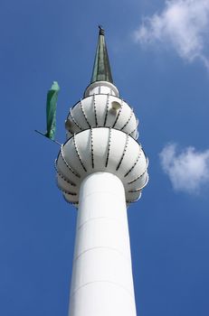 Minaret of mosque in Zagreb with green flag, Croatia