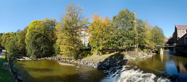 180 degree panoramic view of Akerselva river and Nydalen old industry park in Oslo, Norway during the height of autumn. The image is composed of 9 individual shots.
