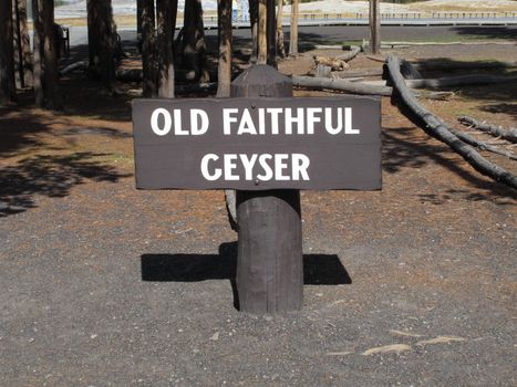 Rustic wooden sign near Old Faithful geyser