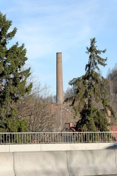 A highway bridge and an old factory pipe. Shot at Nydalen, Oslo, Norway
