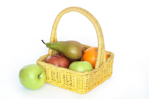 Yellow wicker basket with various fruits isolated on white background with clipping path