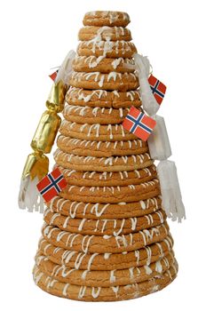 Traditional Norwegian marzipan ring cake - kransekake - seen from side with crackers and Norwegian flags. Isolated with clipping path.
