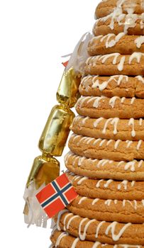 Traditional Norwegian marzipan ring cake - kransekake - seen from side with cracker and Norwegian flag. Isolated with clipping path.
