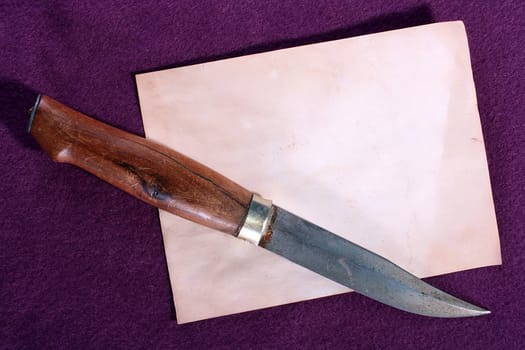 The ancient gangster knife, is made in the nineteenth century against an old paper.