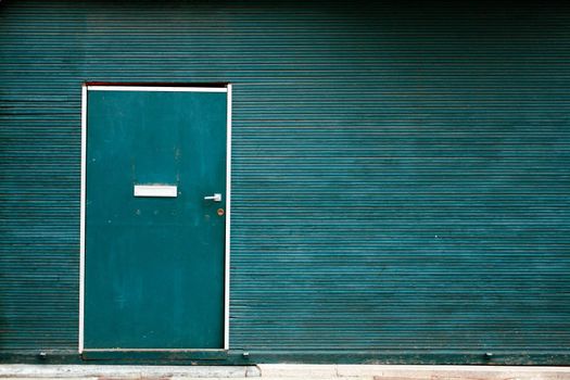 Simple green metallic doors with striped wall