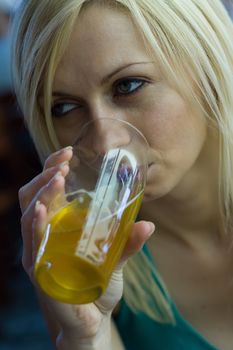 Young woman relaxing with a beer at a bar