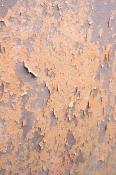 Rusty metal surface with pieces of paint.