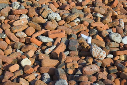 Pile of bricks rounded and weathered by the incoming tide