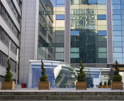 Reflections in a modern glass office building