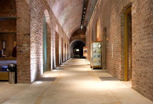 Looking down corridor in ancient building (1854) with arched doorways