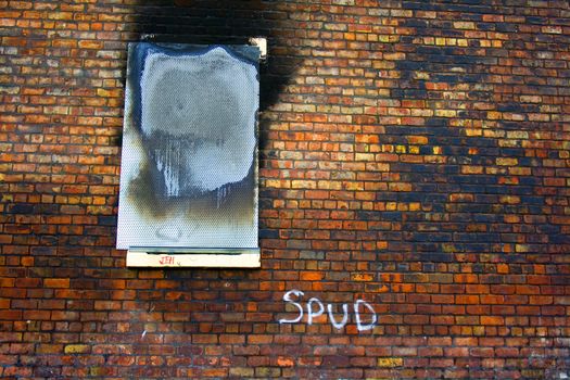 Old wall with burnt out boarded up window