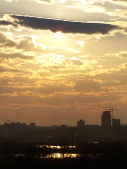 Sun behind cloud. Landscape of right bank of Kyiv, Ukraine. Dneper river.