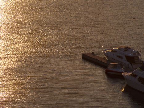 Several boats during sunset time. Evening river.